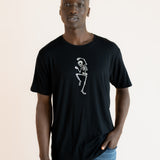 Modal wearing Black Men's Crew Neck Tee with Skeleton print in center over blue jeans on a beige background ::: Model is 6'1" wearing size L ///