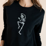 Close up of Modal wearing Black Women's Sweatshirt with Skeleton print in the center on a beige background