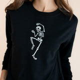 Close up of Modal wearing Black Women's Sweatshirt with Skeleton print in the center on a beige background