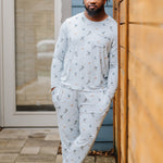 Male model wearing the Men's Jogger Set in Ski leaning against a wooden fence