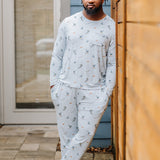 Male model wearing the Men's Jogger Set in Ski leaning against a wooden fence