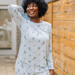 Smiling model wearing the Women's Jogger Pajama Set in Ski with one hand up behind her head
