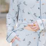Female wearing the Long-Sleeved Women's Pajama Set in Ski holding the hem of the shirt up showing the waist of the pants 