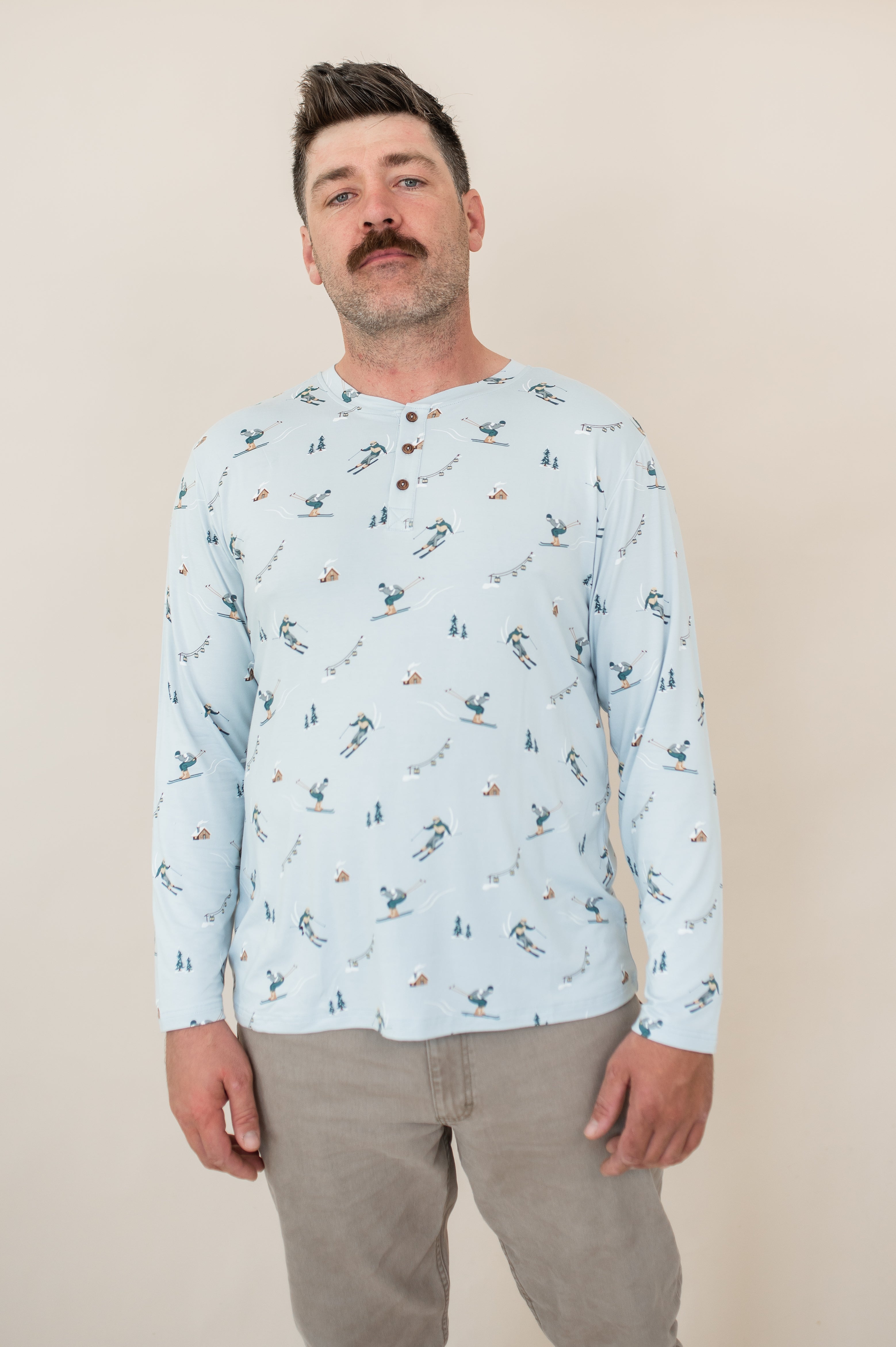 Close up of male modeling the Men's Long Sleeve Henley Top in Ski