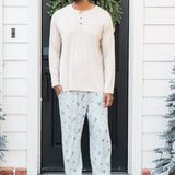 Male model standing in front of a doorway wearing the Men's Lounge Pants in Ski paired with a cream shirt