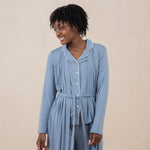 Model smiling to the side while wearing the Women's Robe in Slate and matching Long Sleeve Pajama Set underneath