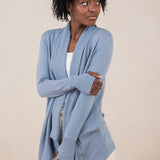 Model with arm crossed across her stomach while wearing the Terry Wrap Top in Slate with light pants