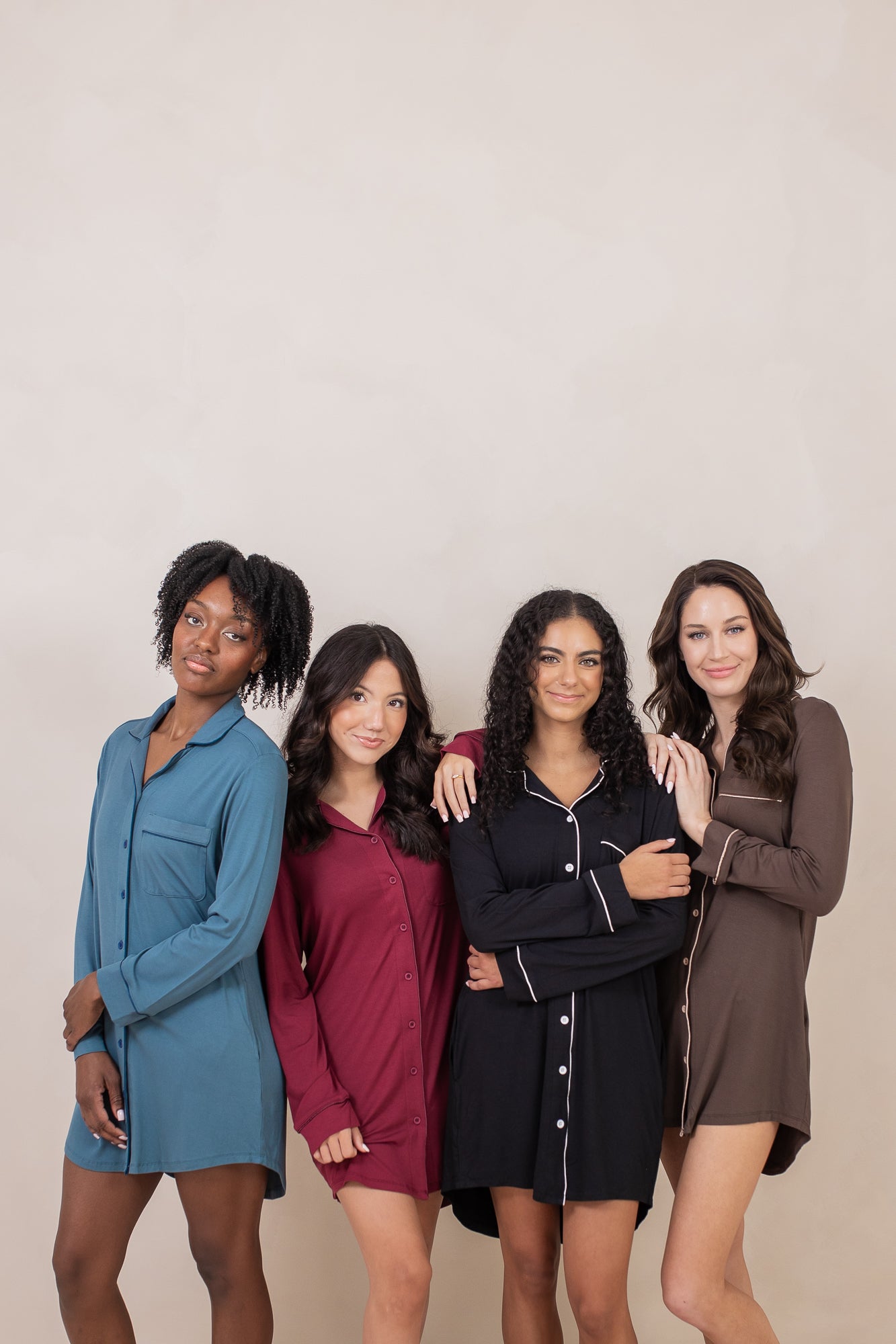 Group of women modeling the Kyte Sleep Shirt in Atlantic, Burgundy, Midnight and Espresso 