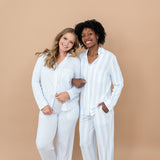 Two female models standing side by side with their arms linked wearing the Long-Sleeved Women's Pajama Set in Big Mist Stripe and Small Mist Stripe