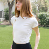 Model looking to the side while wearing the Bamboo Flex Baby Tee in Cloud

::: Model is 5'6" wearing size XS ///