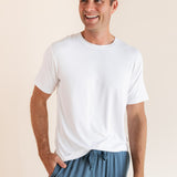 Man modeling Men's Crew Neck Tee laughing in Snow with atlantic lounge pants on.