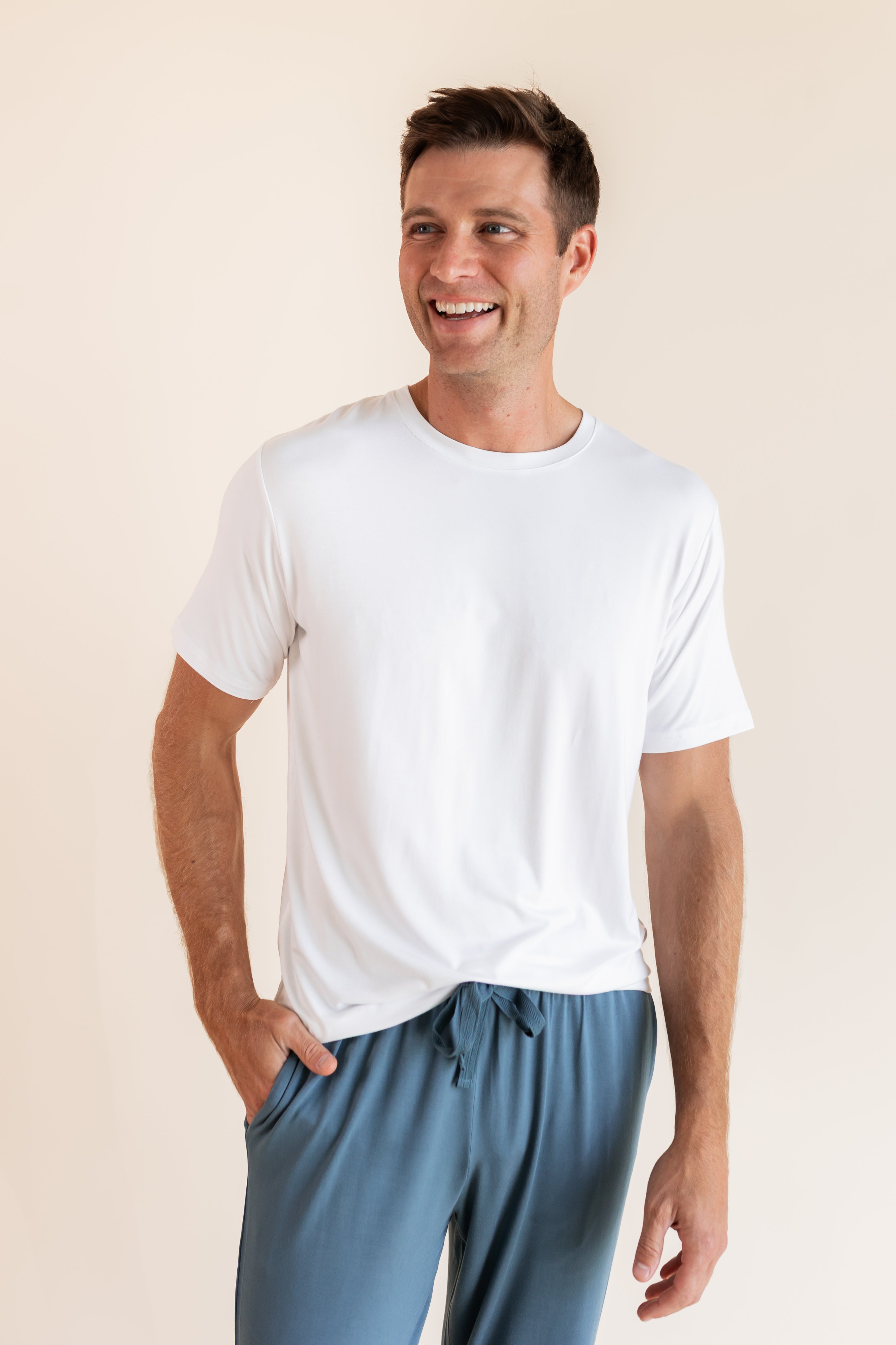 Man modeling Men's Crew Neck Tee laughing in Snow with atlantic lounge pants on.