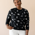 Smiling female wearing the Women's Sweatshirt in STAR WARS™ with cream colored pants

::: Model is 5'1" wearing size S ///
