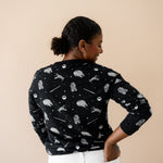 The back of the Women's Sweatshirt in STAR WARS™ shown on a model paired with white jeans