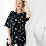 Smiling female posing wearing the Women’s Biker Short Set in STAR WARS™ in front of a white background