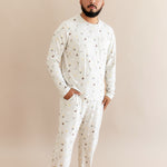 Person wearing a cream men's jogger set with Harry Potter prints on a beige background