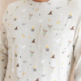 Person wearing a men's jogger set pocket shirt having Harry Potter prints on a cream fabric