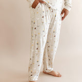 Person wearing men's jogger set pajama with pocket having Harry Potter prints on cream fabric
