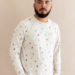 Person wearing a cream Men's jogger set with Harry Potter prints on a beige background
