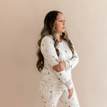 Model looking to the side while wearing the Women's Jogger Pajama Set in Starry Icon 