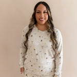 Women wearing a beige Harry Potter patterned joggers set on a beige background