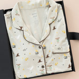 Women's Short Sleeve Pajama Set in Starry Icon print packed in a box on a beige background