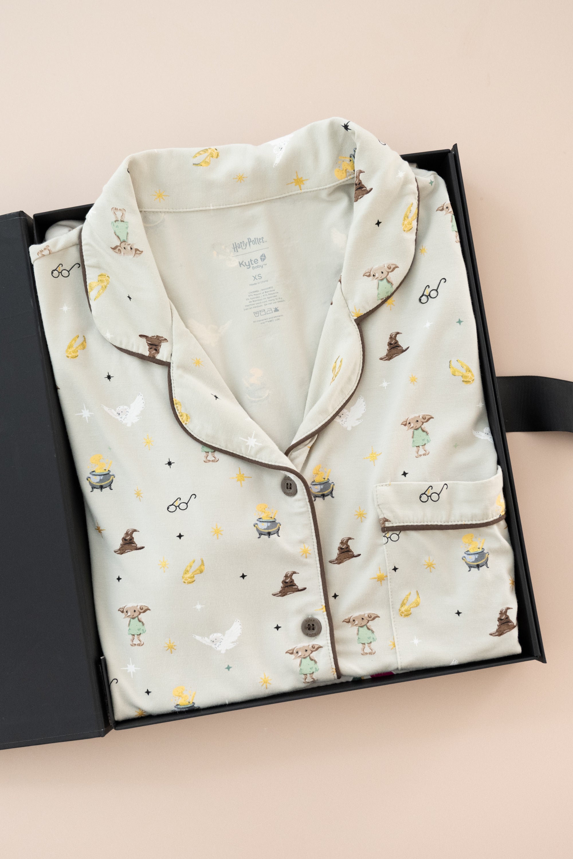 Women's Short Sleeve Pajama Set in Starry Icon print packed in a box on a beige background