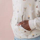 Close up on pocket detail of a beige hoodie with Harry Potter icons printed 