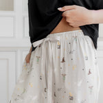 Women's cream lounge pant with Harry Potter pattern on it with drawstring.