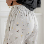 Back side of a cream Harry Potter patterned women's lounge pant with pockets.