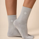 Gray socks worn by a person on a beige background