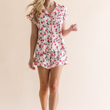 Smiling model looking to the side while wearing the Women's Short Sleeve Pajama Set in Strawberry Fields
