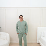 Man modeling Men's Lounge Pants in Thyme with matching henley tee