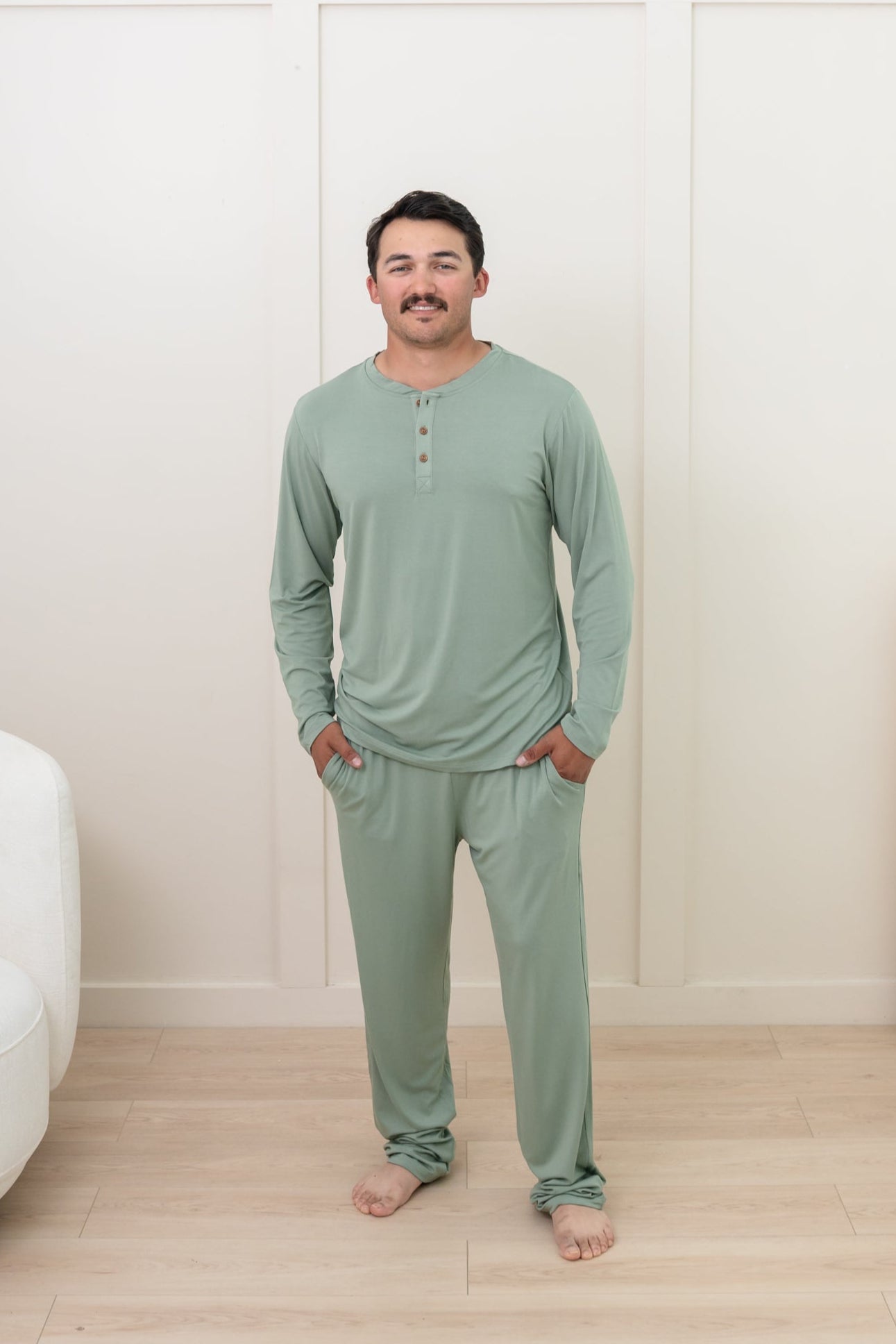 Man modeling Men's Lounge Pants in Thyme with matching henley tee
