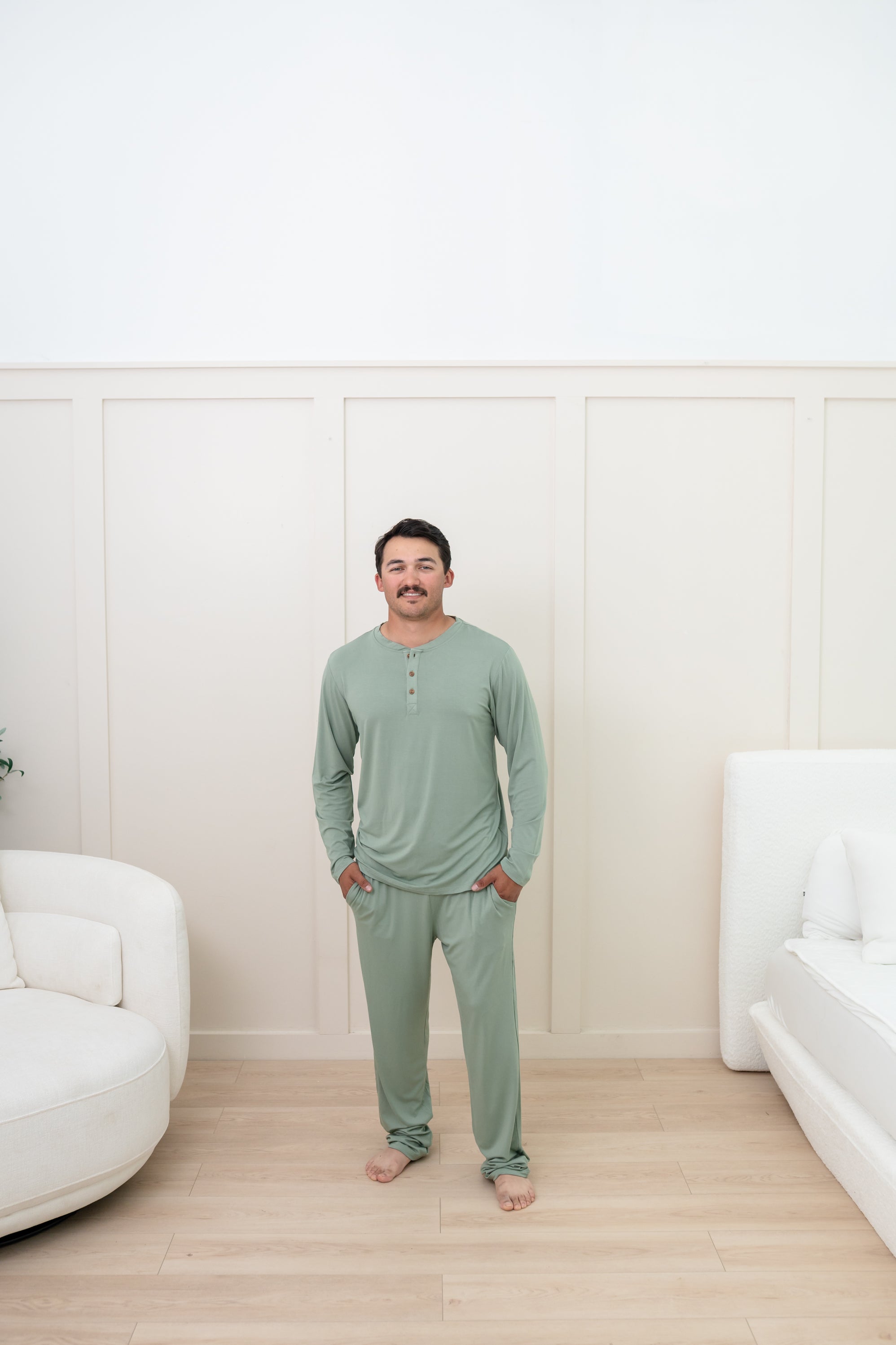 Man modeling Men's Lounge Pants in Thyme with matching henley tee