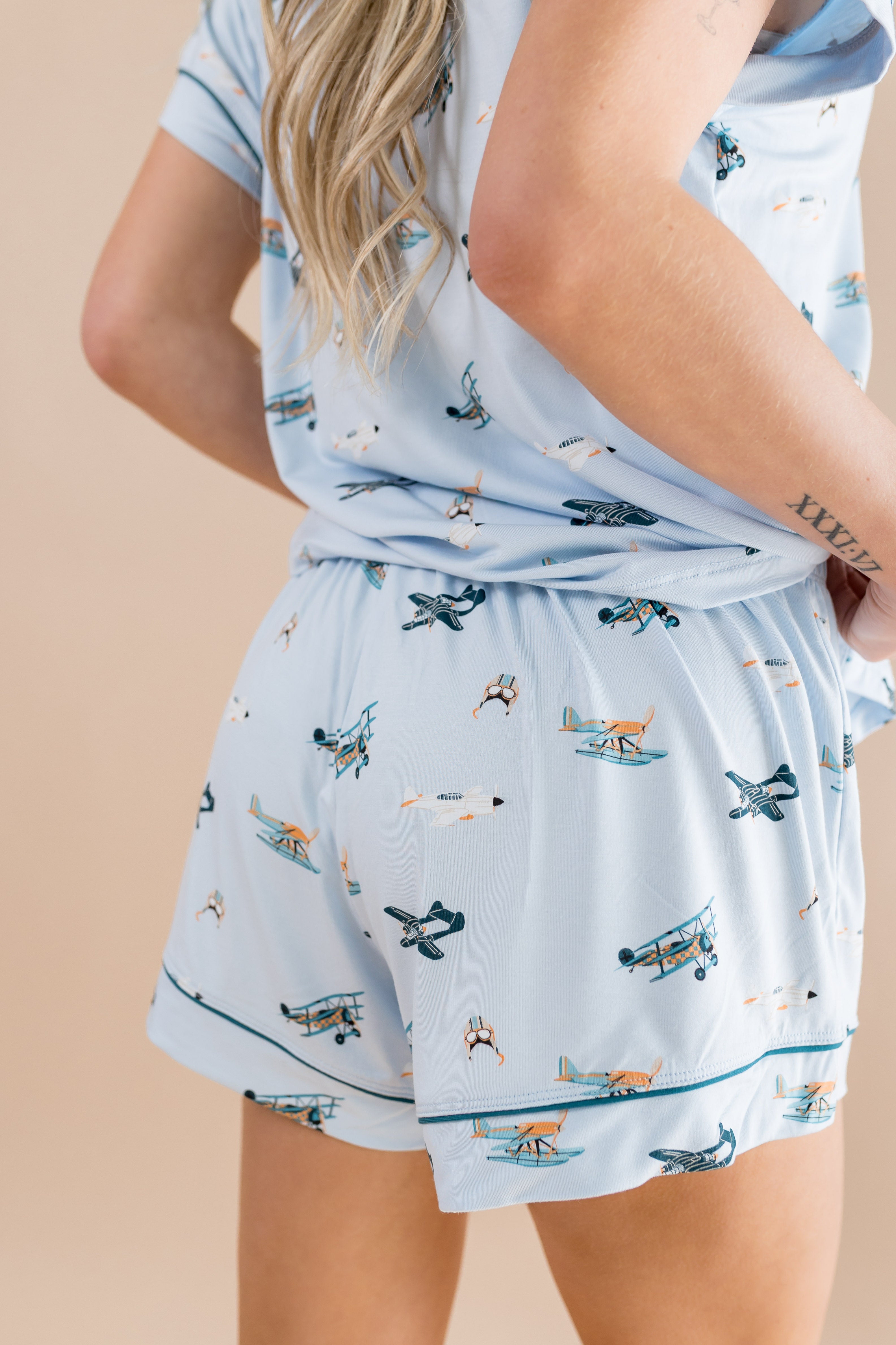 Model showasing the back side of the bottoms of the Bamboo Women's Short Sleeve Pajama Set in Take Off 