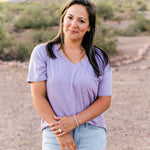 Female wearing the Women’s Relaxed Fit V-Neck in Taro paired with a light wash jean