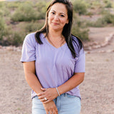 Female wearing the Women’s Relaxed Fit V-Neck in Taro paired with a light wash jean