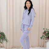 Female model wearing the Women's Ribbed Jogger Pant in Taro with one hand in pants pocket