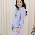 Female model in the Women's Ribbed Hoodie in Taro paired with Taro Jogger Pants
