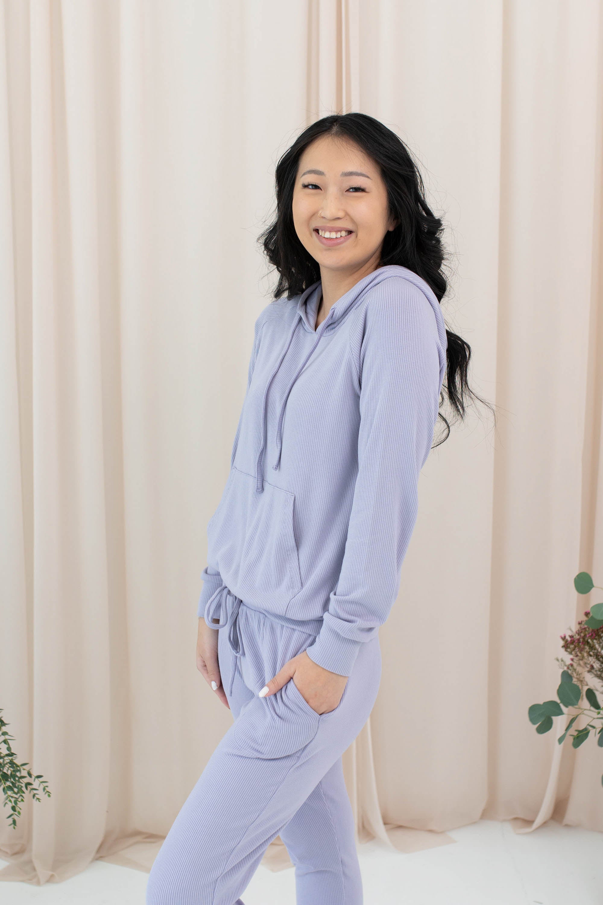 Female model in the Women's Ribbed Hoodie in Taro paired with Taro Jogger Pants