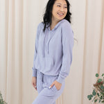 Model wearing the Women's Ribbed Jogger Pant in Taro with one hand in pants pocket