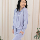 Model wearing the Women's Ribbed Jogger Pant in Taro with one hand in pants pocket
