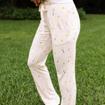 Side view of the Women's Lounge Pants in Tennis on a model standing in the grass
