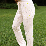 Side view of the Women's Lounge Pants in Tennis on a model standing in the grass