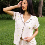 Model with one arm in hair while looking to the side and wearing the Women's Short Sleeve Pajama Set in Tennis

::: Model is 5'6" wearing size XS ///