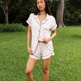 Woman modeling the Women's Short Sleeve Pajama Set in Tennis in a green yard