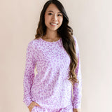 Model wearing Women's Jogger pajama set in Thistle Leopard print on a beige background