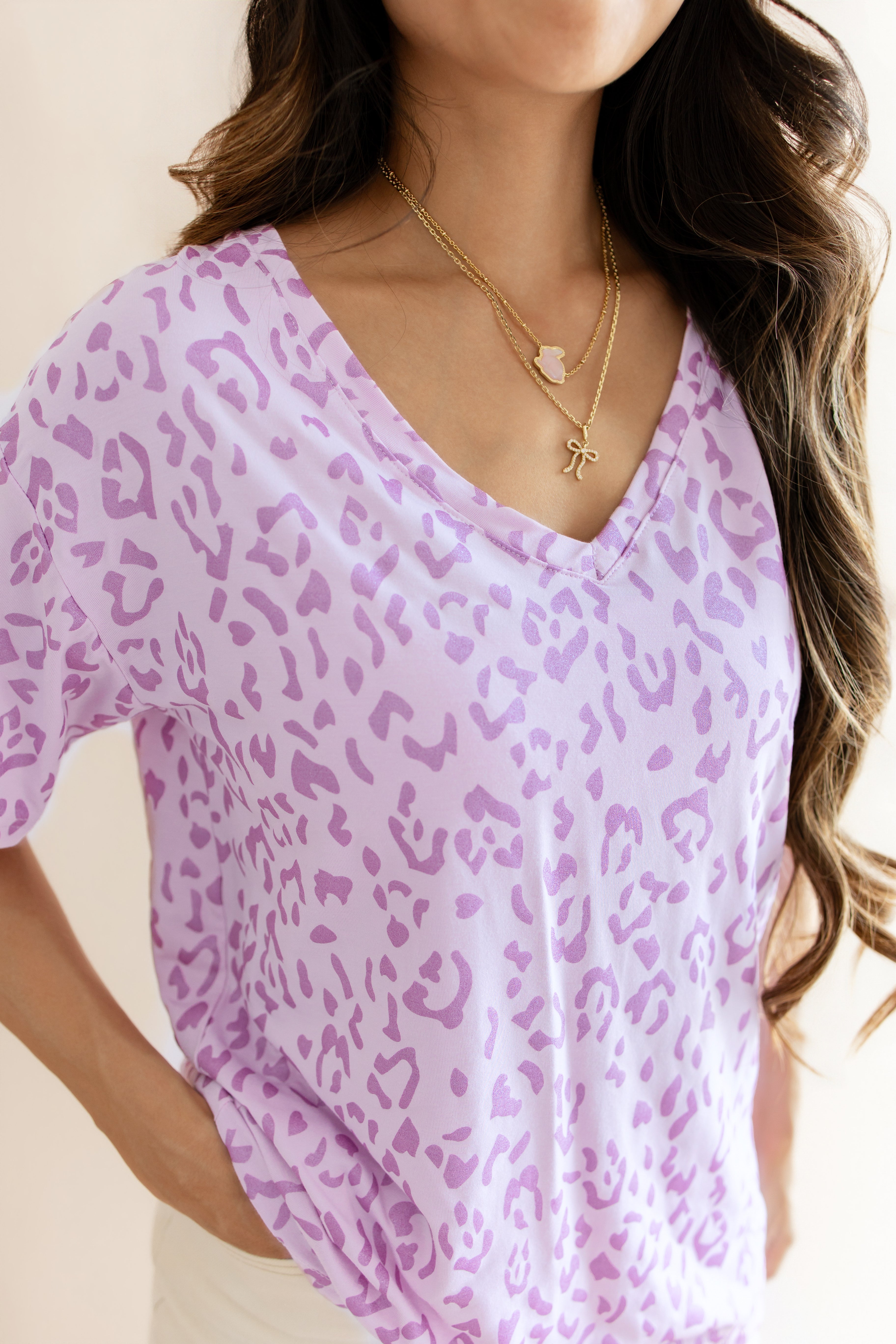 Women's Relaxed Fit V-Neck in Thistle Leopard print over a white pant on a beige background ::: Model is 5'3" wearing size S ///