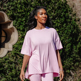 Model looking to the side while standing in front of a wall of greenery while wearing the Kyte Bamboo Women’s Biker Short Set in Thistle
::: Model is 5'9" wearing size M ///